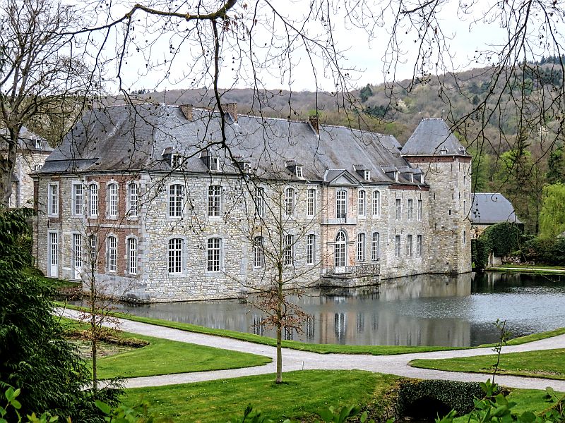 Castle at the water in the middle of a green park, Annevoie Castle in Wallonia, Belgium