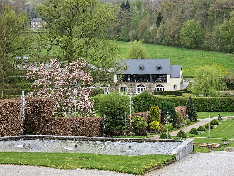 Beautiful park with water cascades and fountains and trees in blossom during spring time. Annevoie Gardens in Wallonia, Belgium