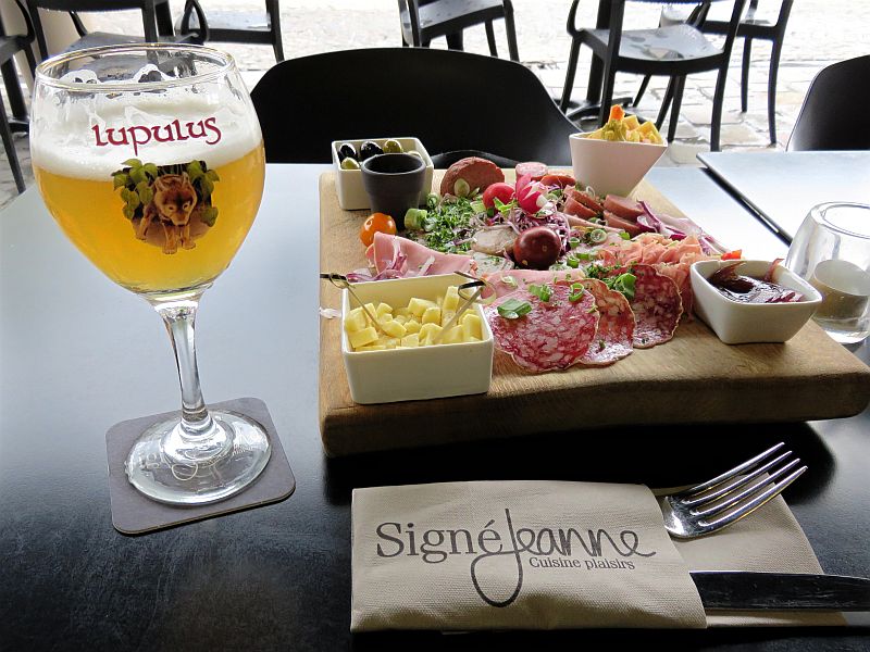 Lupulus beer, antipasti with salami, olives and cheese on a table in a cafe in La Roche en Ardenne, Belgium, Wallonia
