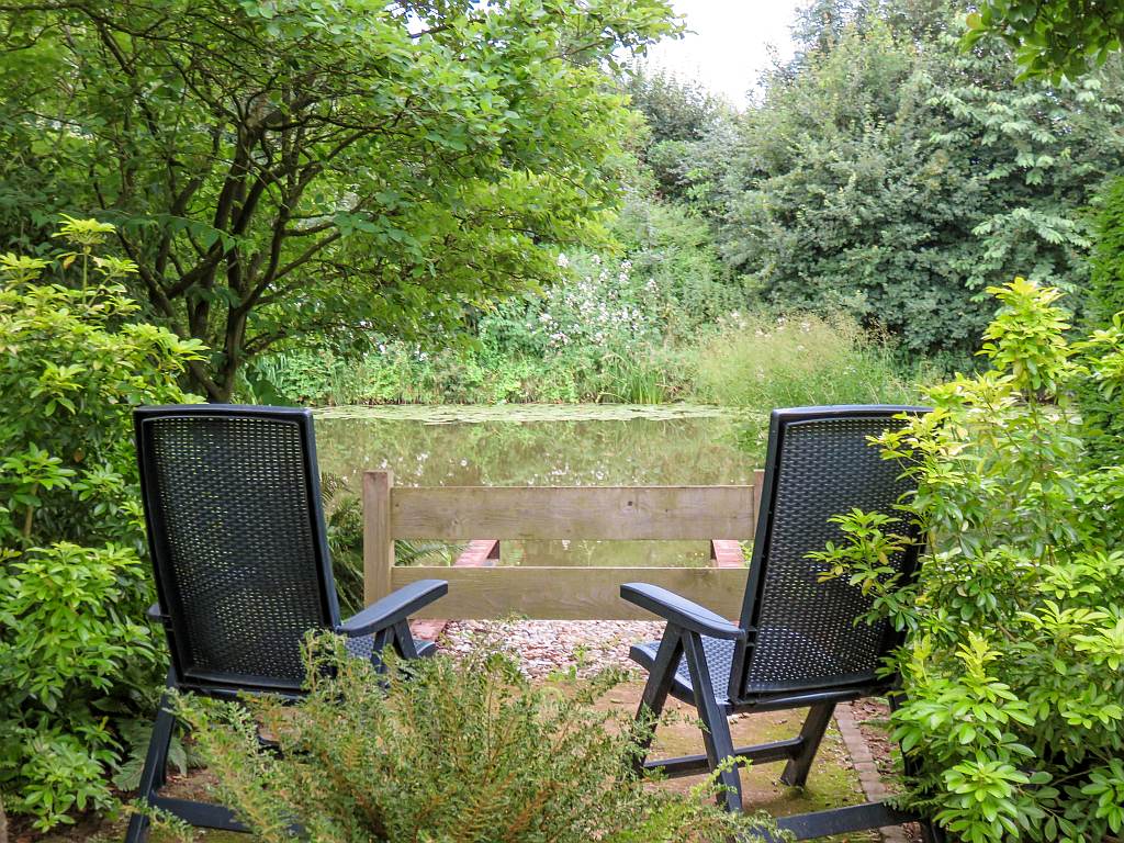 two chairs in the middle of lush green park at Appeltern Gardens