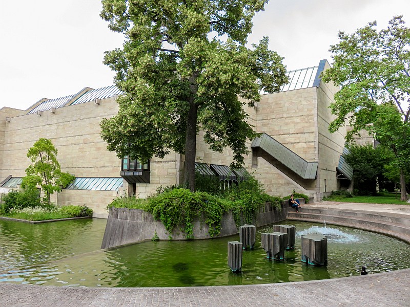 a modern building with water pond and fountains in front, Neue Pinakothek in Munich Germany