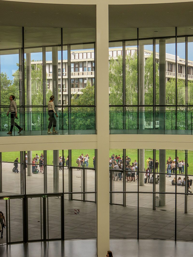 view through glass windows from the second floor of a modern building, Pinakothek der Moderne in Munich Germany