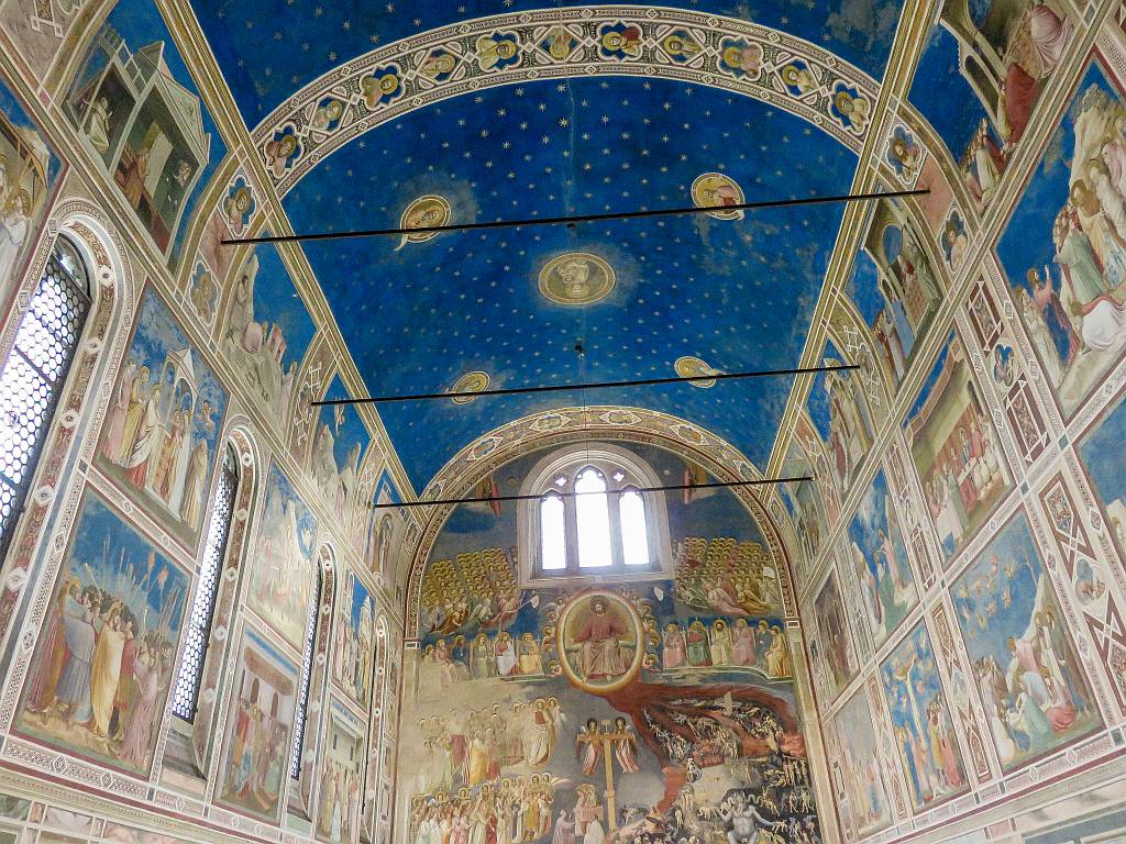 an interior of a church all frescoed in blue colour, the interior of the Scrovegni Chapel in Padua