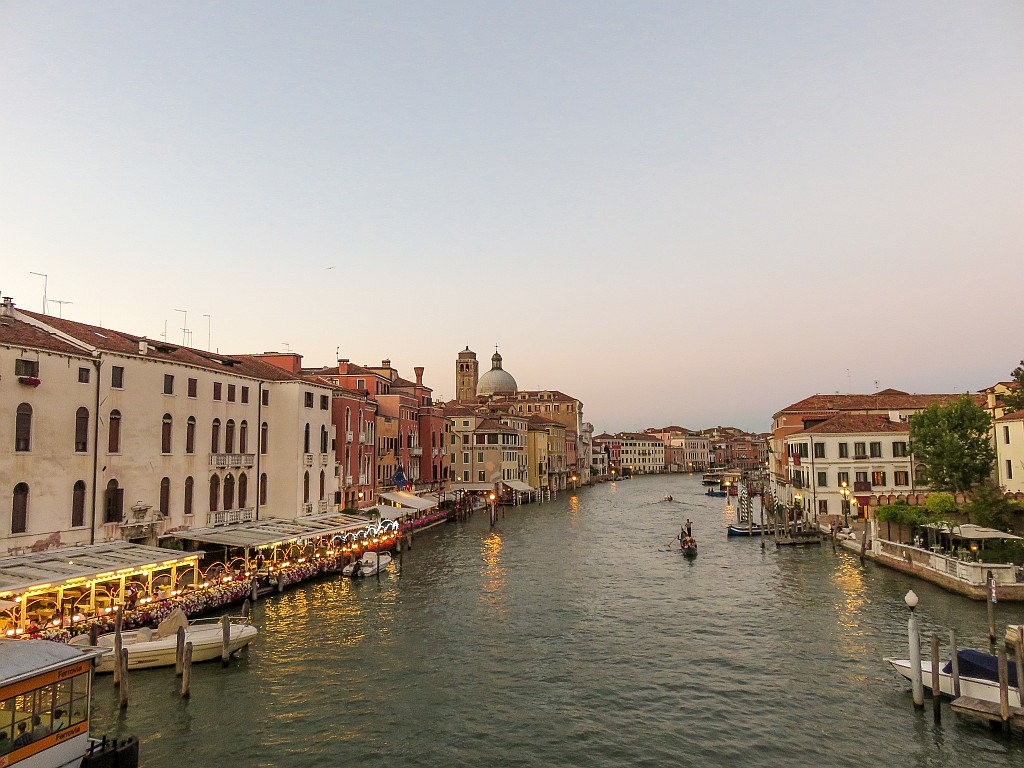 a canal lined up with houses and boats on it at sunset, Canal Grande in Venice at sunset