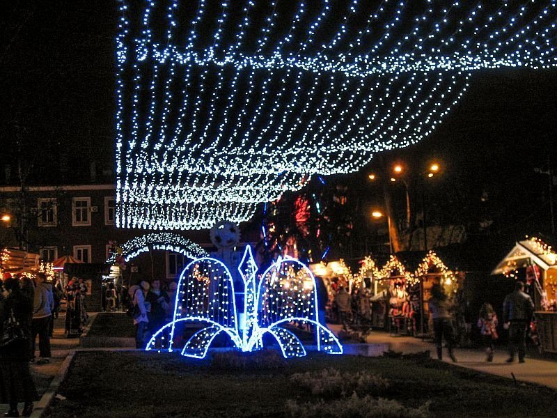 Christmas stalls on both sides with some hanging lights, the Christmas village in Veliko Tarnovo, Bulgaria