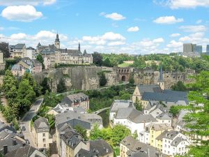 a view from the top to an old town along a bend of a river, Luxembourg Old TOwn UNESCO World Heritage Site