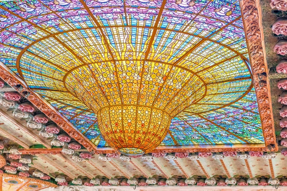 a gorgeous ceiling with colorful stained glass, the ceiling of Palau de la Musica in Barcelona, Spain