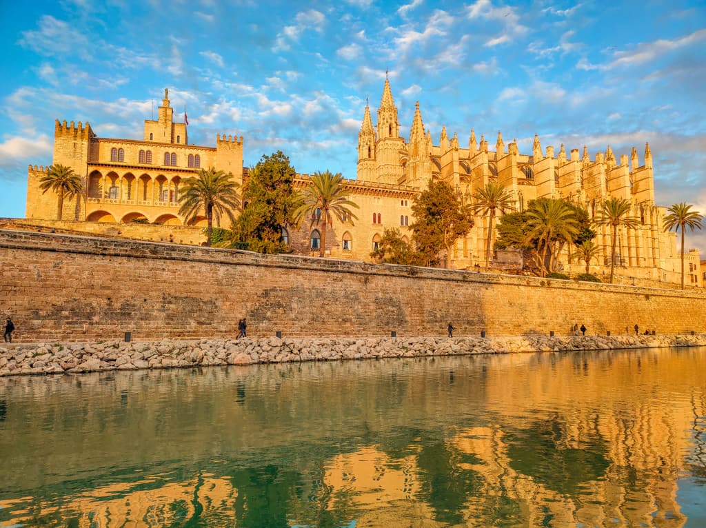 La Seu and La Almudeina at sunset reflecting in the water - one of the best things to see in Palma de Mallorca