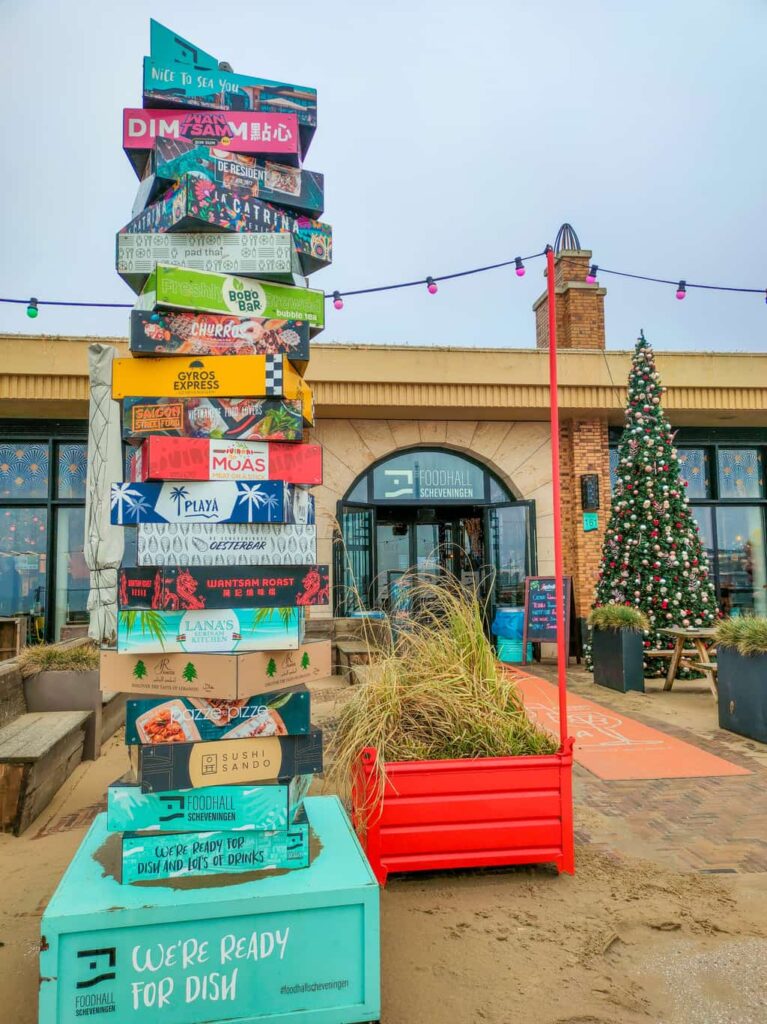 the entrance of the Foodhall in Scheveningen with a Christmas tree in front