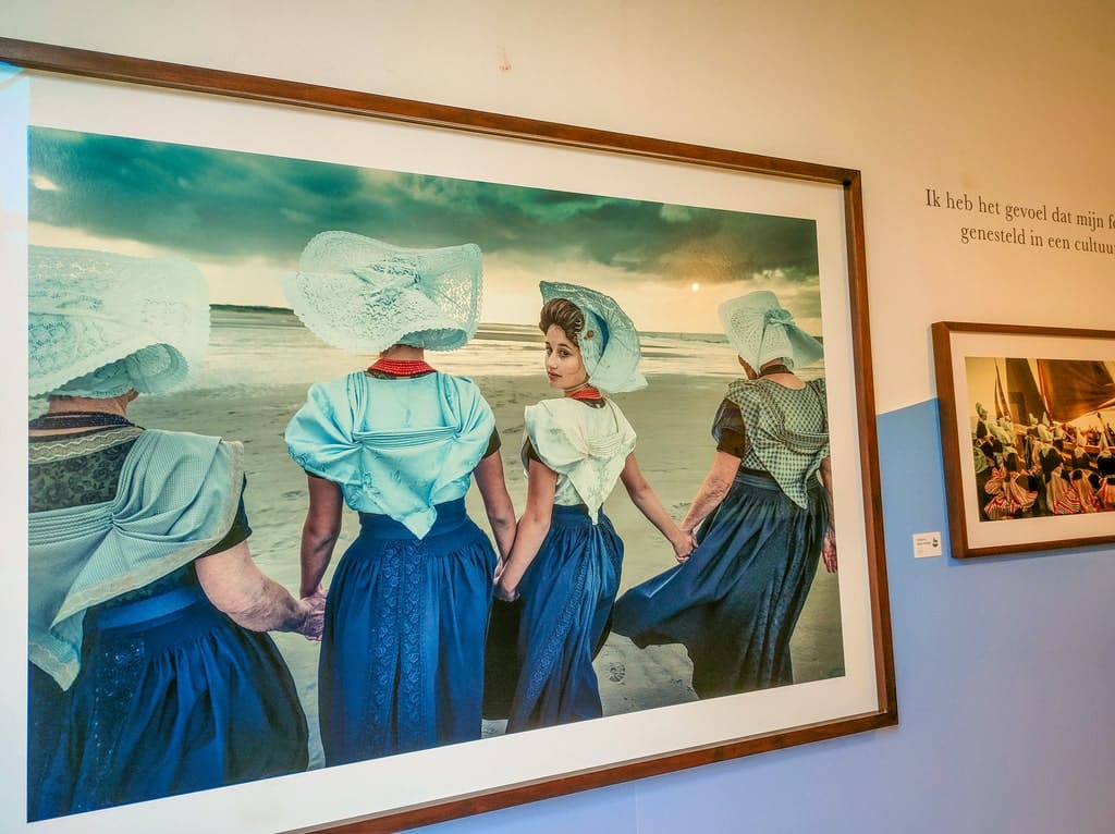 photographs of people in traditional Dutch costumes in a museum; Ode to Netherlands exhibition