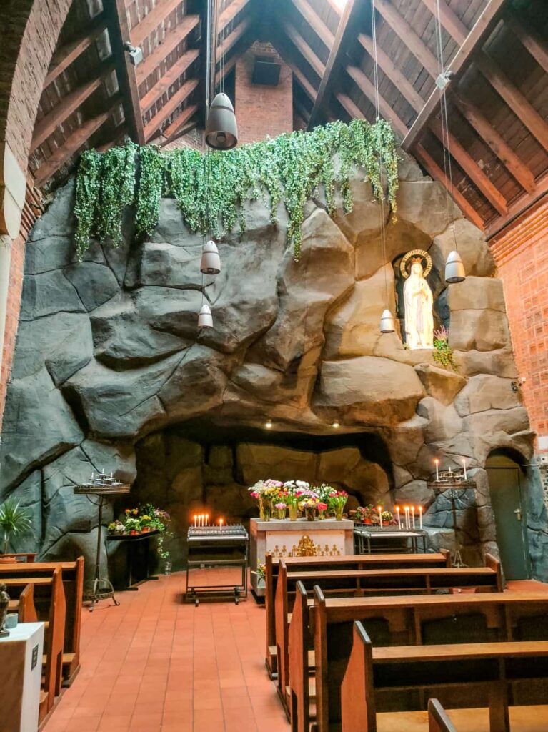 a model of a cave in a church with the statue of Virgin Mary; a copy of the Grotto in Lourdes in Scheveningen