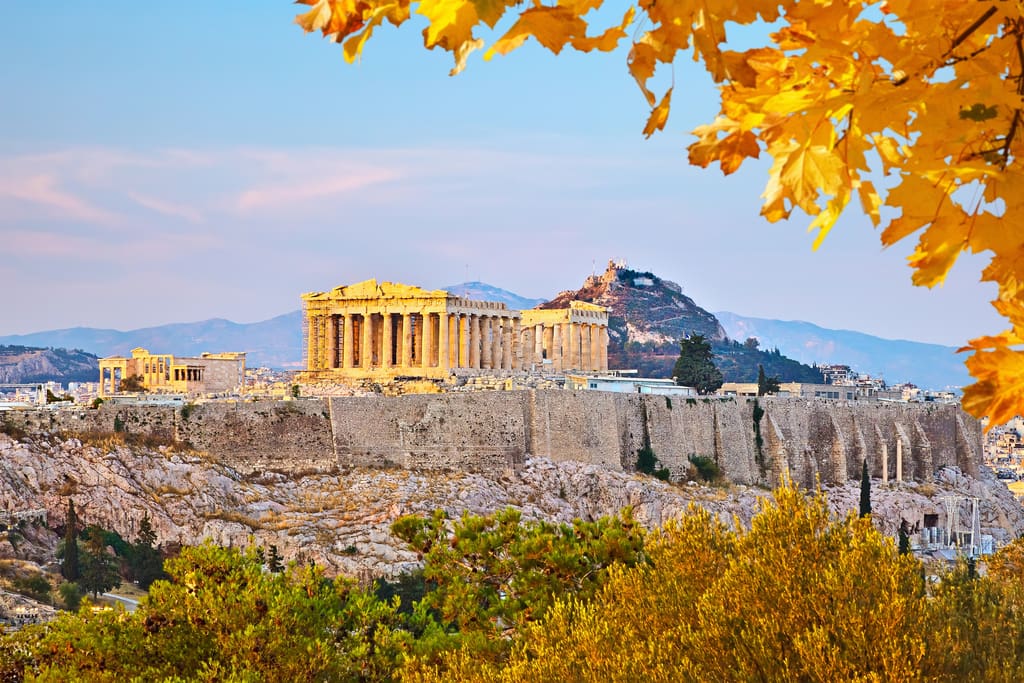 Acropolis and Parthenon in Athens with autumn leaves in the foreground